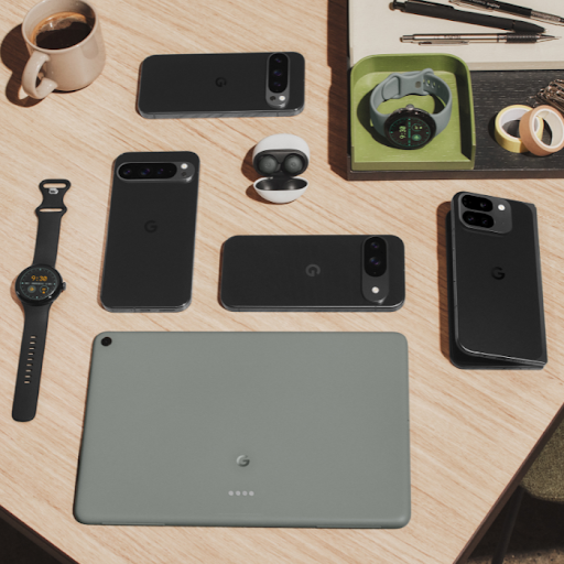 Google Pixel phones, tablets, Wear OS watches and earbuds displayed on a table.